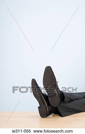 Feet of businessman on desk View Large Photo Image Stock Photography - Feet of businessman on desk. Fotosearch
