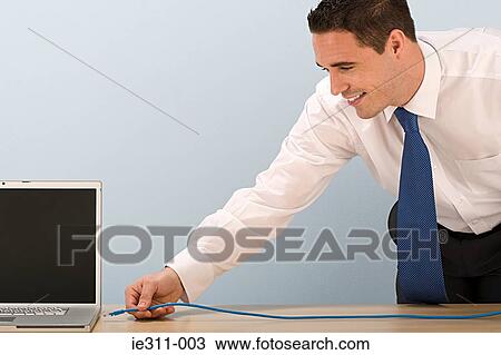 Man with network cable View Large Photo Image Stock Image - Man with network cable. Fotosearch