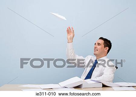 Office worker with paper aeroplane View Large Photo Image Stock Image - Office worker with paper aeroplane. Fotosearch