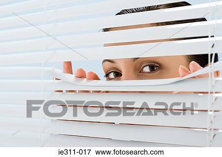 Woman looking though blinds View Large Photo Image Stock Photo - Woman looking though blinds. Fotosearch