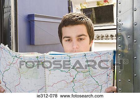 A teenage boy looking at a map View Large Photo Image Stock Photo - A teenage boy looking at a map. Fotosearch