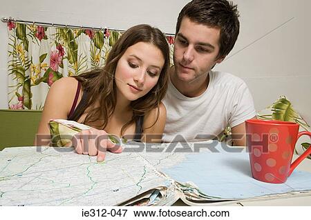 A teenage couple looking at a map View Large Photo Image Stock Photo - A teenage couple looking at a map. Fotosearch