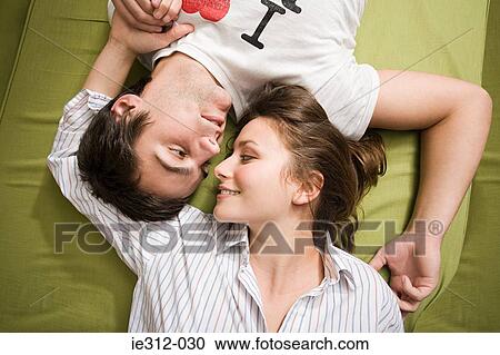 A teenage couple lying down View Large Photo Image Stock Image - A teenage couple lying down. Fotosearch
