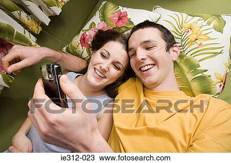A teenage couple photographing themselves View Large Photo Image Stock Image - A teenage couple photographing themselves. Fotosearch
