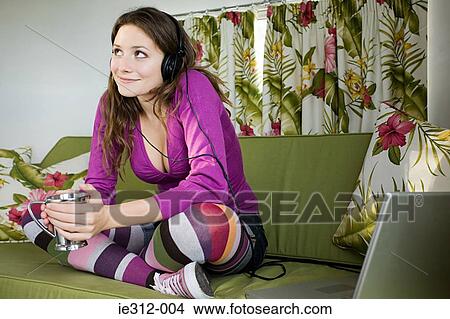 Picture - A teenage girl listening to music. Fotosearch