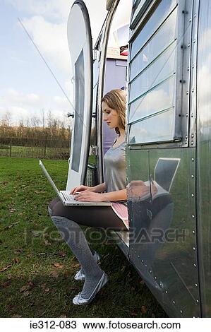 Stock Image - A teenage girl using a laptop. Fotosearch