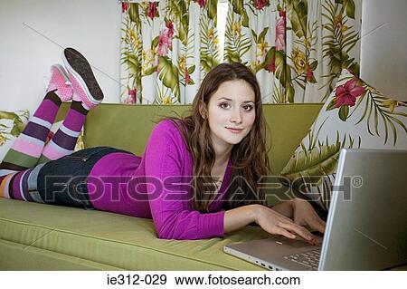 A teenage girl using a laptop View Large Photo Image Stock Photo - A teenage girl using a laptop. Fotosearch