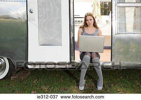 Stock Photo - A teenage girl using a laptop. Fotosearch
