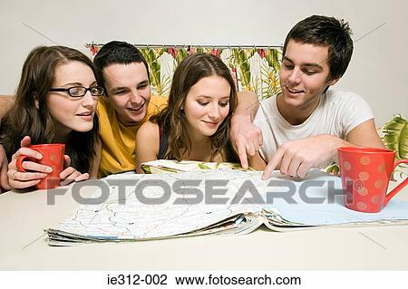 Friends looking at a map View Large Photo Image Stock Image - Friends looking at a map. Fotosearch