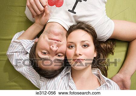 Portrait of a couple lying down View Large Photo Image Stock Photograph - Portrait of a couple lying down. Fotosearch