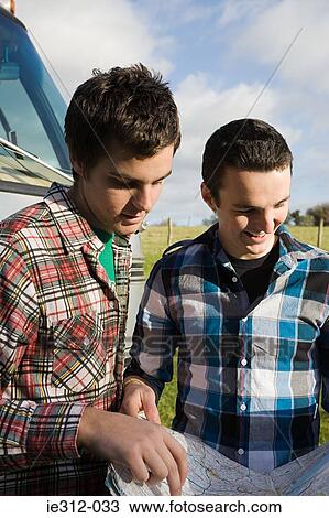 Teenage boys looking at a map View Large Photo Image Stock Image - Teenage boys looking at a map. Fotosearch