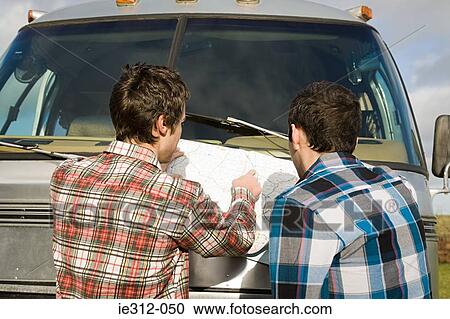 Teenage boys looking at a map View Large Photo Image Stock Image - Teenage boys looking at a map. Fotosearch