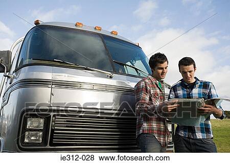 Teenage boys looking at a map View Large Photo Image Stock Photo - Teenage boys looking at a map. Fotosearch