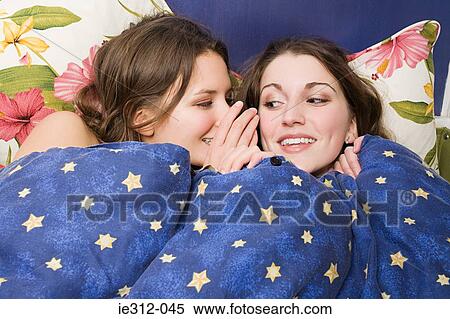Stock Photography - Teenage girls whispering. Fotosearch