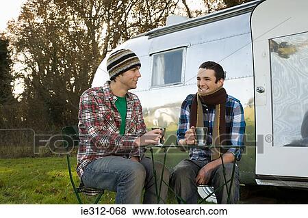 Two teenage boys sat outside a caravan View Large Photo Image Stock Photo - Two teenage boys sat outside a caravan. Fotosearch