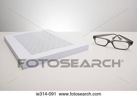 Eyeglasses and a stack of paper View Large Photo Image Stock Image - Eyeglasses and a stack of paper . Fotosearch