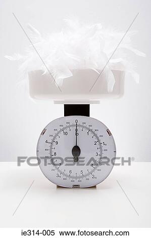 Feathers on a weight scales View Large Photo Image Stock Photography - Feathers on a weight scales. Fotosearch