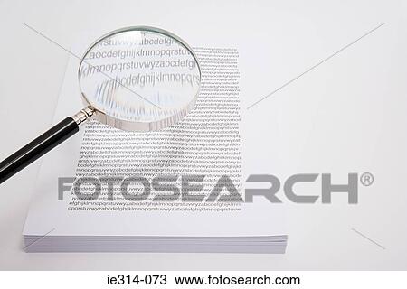 Magnifying glass and a stack of paper View Large Photo Image Stock Image - Magnifying glass and a stack of paper. Fotosearch