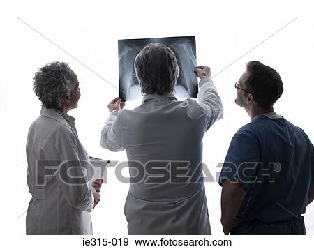 Doctors and surgeon looking at x-ray View Large Photo Image Stock Photo - Doctors and surgeon looking at x-ray. Fotosearch