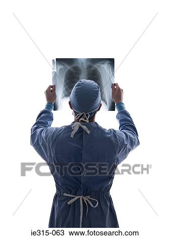 Surgeon looking at x-ray View Large Photo Image Stock Image - Surgeon looking at x-ray. Fotosearch