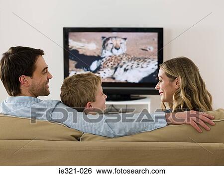 A family watching tv and talking View Large Photo Image Stock Photograph - A family watching tv and talking. Fotosearch