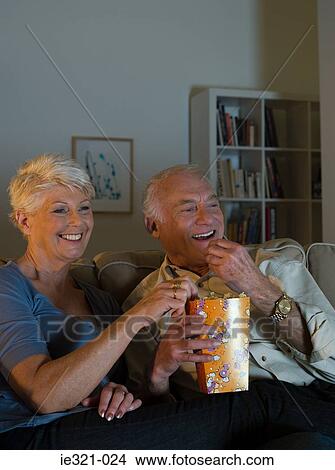 A senior couple watching tv View Large Photo Image Picture - A senior couple watching tv. Fotosearch
