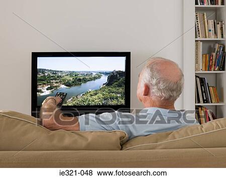 A senior man watching tv View Large Photo Image Stock Photo - A senior man watching tv. Fotosearch