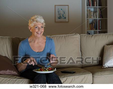 A senior woman having a tv dinner View Large Photo Image Stock Photo - A senior woman having a tv dinner. Fotosearch