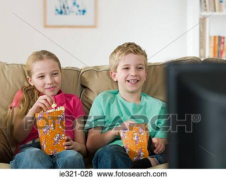 A sister and brother watching tv View Large Photo Image Stock Photo - A sister and brother watching tv. Fotosearch