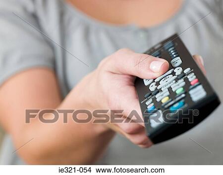 A woman pointing a remote control View Large Photo Image Picture - A woman pointing a remote control. Fotosearch