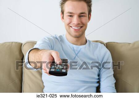 A young man watching tv View Large Photo Image Stock Photography - A young man watching tv. Fotosearch