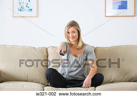 A young woman watching tv View Large Photo Image Stock Image - A young woman watching tv. Fotosearch