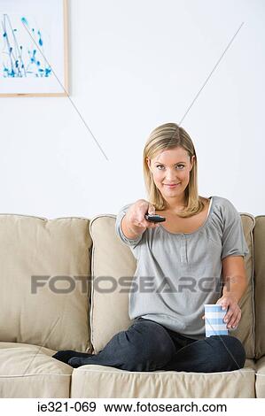 A young woman watching tv View Large Photo Image Stock Photo - A young woman watching tv. Fotosearch