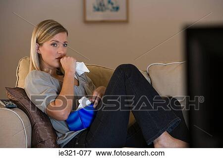 A young woman watching tv View Large Photo Image Stock Photo - A young woman watching tv. Fotosearch