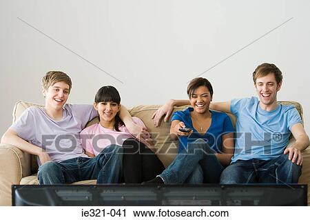 Stock Image - Friends watching tv. Fotosearch