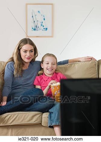 Mother and daughter watching tv View Large Photo Image Stock Image - Mother and daughter watching tv. Fotosearch