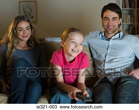 Parents watching tv with their daughter View Large Photo Image Stock Image - Parents watching tv with their daughter. Fotosearch