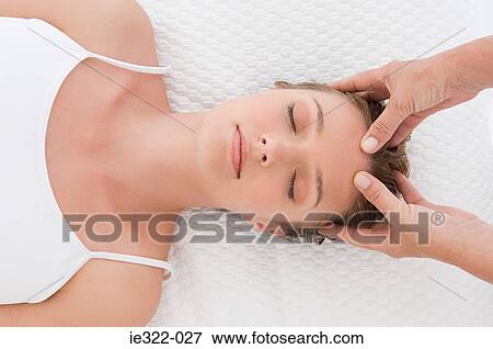 Stock Photo - A woman having a head massage. Fotosearch