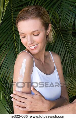 A woman moisturising her arm View Large Photo Image Stock Photography - A woman moisturising her arm. Fotosearch