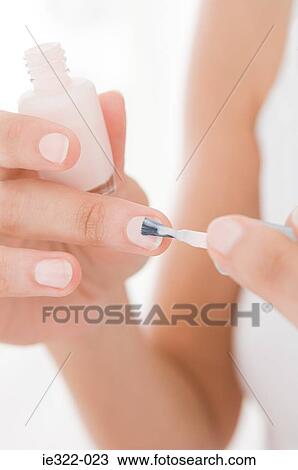 A woman painting her nails View Large Photo Image Stock Image - A woman painting her nails. Fotosearch