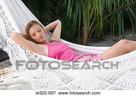 A woman sleeping in a hammock View Large Photo Image Stock Photo - A woman sleeping in a hammock. Fotosearch