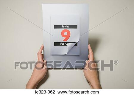A person holding a calendar date View Large Photo Image Stock Image - A person holding a calendar date. Fotosearch