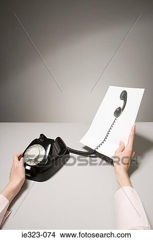 A phone and a photograph of a telephone receiver View Large Photo Image Picture - A phone and a photograph of a telephone receiver. Fotosearch