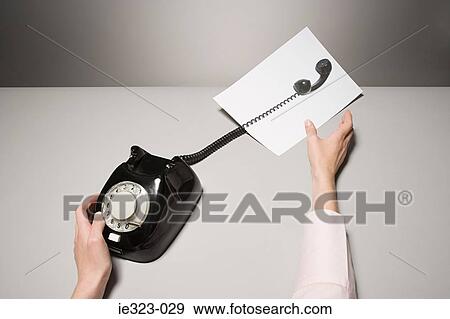 A phone and a photograph of a telephone receiver View Large Photo Image Stock Photo - A phone and a photograph of a telephone receiver. Fotosearch