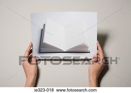 A woman holding a photograph of a book View Large Photo Image Stock Photo - A woman holding a photograph of a book. Fotosearch