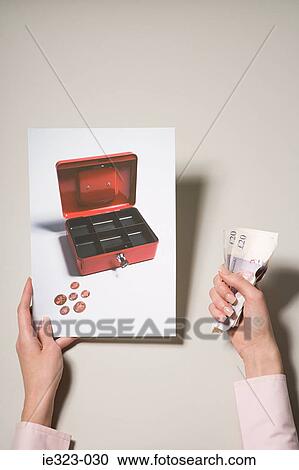 A woman holding a photograph of a cash box and a key View Large Photo Image Stock Image - A woman holding a photograph of a cash box and a key. Fotosearch