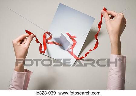 A woman holding a photograph of a gift View Large Photo Image Stock Photo - A woman holding a photograph of a gift. Fotosearch
