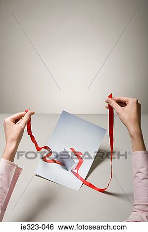 A woman holding a photograph of a gift View Large Photo Image Stock Photograph - A woman holding a photograph of a gift. Fotosearch