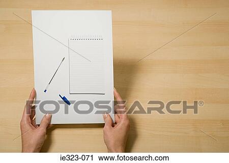 A woman holding a photograph of a notebook and pen View Large Photo Image Stock Image - A woman holding a photograph of a notebook and pen. Fotosearch