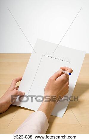 A woman holding a photograph of a notebook and a pen View Large Photo Image Stock Photo - A woman holding a photograph of a notebook and a pen. Fotosearch